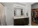 Bathroom featuring a single vanity, large mirror, and access to a walk-in closet at 972 Redwood Dr, Franklin, IN 46131