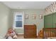 Comfortable Bedroom includes green walls, leaf wallpaper, and a bright window at 972 Redwood Dr, Franklin, IN 46131
