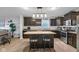 Updated kitchen with dark cabinetry, granite countertops, and a functional center island with bar stools at 972 Redwood Dr, Franklin, IN 46131