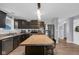 Modern kitchen featuring stainless steel appliances, dark cabinets, and a center island with seating at 972 Redwood Dr, Franklin, IN 46131