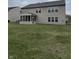 Exterior view of a home with green lawn and screened in back porch at 10072 Graceful Landing Dr, Indianapolis, IN 46234