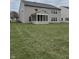 Backyard featuring green grass, a two story home and a screen porch, perfect for entertaining at 10072 Graceful Landing Dr, Indianapolis, IN 46234