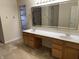 Bathroom featuring double sinks, bright lighting and large vanity mirror at 10072 Graceful Landing Dr, Indianapolis, IN 46234