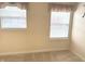 Bedroom featuring windows providing natural light, neutral walls, carpet, and base molding at 10072 Graceful Landing Dr, Indianapolis, IN 46234