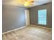 Carpeted bedroom with gray walls and window letting in natural light at 10072 Graceful Landing Dr, Indianapolis, IN 46234