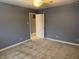 Bedroom featuring gray walls, neutral carpet, and a doorway to another room at 10072 Graceful Landing Dr, Indianapolis, IN 46234