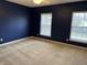 Bedroom with blue walls, neutral carpet, and two windows with blinds at 10072 Graceful Landing Dr, Indianapolis, IN 46234