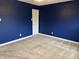 Bedroom featuring blue walls, neutral carpet and a door to another room at 10072 Graceful Landing Dr, Indianapolis, IN 46234