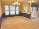 Dining room with large windows offering natural light, neutral carpeting, and stylish chandelier at 10072 Graceful Landing Dr, Indianapolis, IN 46234