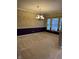 Spacious dining room featuring neutral carpet, chandelier lighting, and large windows at 10072 Graceful Landing Dr, Indianapolis, IN 46234
