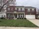 Charming two-story brick home with manicured lawn and covered front porch at 10072 Graceful Landing Dr, Indianapolis, IN 46234