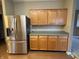 Kitchen featuring stainless steel LG refrigerator, wooden cabinets and green countertops at 10072 Graceful Landing Dr, Indianapolis, IN 46234
