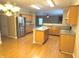 Modern kitchen featuring stainless steel appliances, a kitchen island, and hardwood floors at 10072 Graceful Landing Dr, Indianapolis, IN 46234