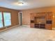 View of living room featuring carpeted floors and a large wooden cabinet at 10072 Graceful Landing Dr, Indianapolis, IN 46234