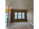 Empty living room featuring neutral walls, carpet, and large windows at 10072 Graceful Landing Dr, Indianapolis, IN 46234