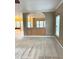 Open-concept living area with built-in shelving, neutral carpeting, and a large window for natural light and views at 10072 Graceful Landing Dr, Indianapolis, IN 46234