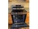 Modern stainless steel oven with a glass stovetop and warming settings at 10072 Graceful Landing Dr, Indianapolis, IN 46234