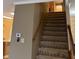 Carpeted staircase with wooden handrail leading to the upper level at 10072 Graceful Landing Dr, Indianapolis, IN 46234