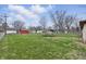 Spacious backyard featuring lush green grass, mature trees, and a trampoline for outdoor fun and recreation at 1114 S Avon Ave, Avon, IN 46123