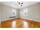 Bedroom featuring hardwood floors, two windows, a ceiling fan and a built in shelf at 1114 S Avon Ave, Avon, IN 46123