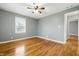 This bedroom features hardwood floors, neutral paint, and a ceiling fan with a light fixture at 1114 S Avon Ave, Avon, IN 46123