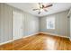 This bedroom features gleaming hardwood floors, neutral walls, and a ceiling fan with light fixture at 1114 S Avon Ave, Avon, IN 46123
