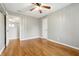 This light-filled bedroom features hardwood floors, a ceiling fan, and an alcove with closet shelving at 1114 S Avon Ave, Avon, IN 46123
