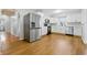Modern kitchen with stainless steel appliances, white cabinets, and wood-look flooring at 1114 S Avon Ave, Avon, IN 46123
