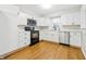 Updated kitchen boasting white cabinets, stainless steel appliances, and durable wood-look flooring at 1114 S Avon Ave, Avon, IN 46123
