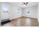 Light-filled living room with durable flooring, neutral walls, and a ceiling fan with light fixture at 1114 S Avon Ave, Avon, IN 46123