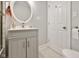 Well-lit bathroom featuring a modern vanity, an oval mirror, and a convenient toilet paper holder at 118 W Fordice St, Lebanon, IN 46052