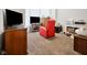 Cozy bedroom with a red recliner, TV, and carpet flooring at 118 W Fordice St, Lebanon, IN 46052