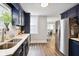 Modern kitchen featuring stainless steel appliances, navy cabinets, and sleek countertops at 118 W Fordice St, Lebanon, IN 46052
