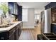 Modern kitchen featuring stainless steel appliances, navy cabinets, and sleek countertops at 118 W Fordice St, Lebanon, IN 46052