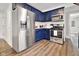 This home features a modern kitchen with stainless steel appliances and beautiful blue cabinets at 118 W Fordice St, Lebanon, IN 46052