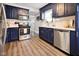Stylish kitchen featuring stainless steel appliances, navy cabinets, and sleek backsplash at 118 W Fordice St, Lebanon, IN 46052