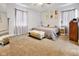 Comfortable bedroom featuring a large bed, carpeted floors, and windows for natural light at 118 W Fordice St, Lebanon, IN 46052
