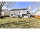 Backyard with a deck, patio, hot tub, and expansive lawn, ideal for relaxation and recreation at 12527 Trester Ln, Fishers, IN 46038