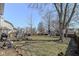 Expansive backyard featuring a play set, seating, grill, and mature trees, perfect for outdoor enjoyment at 12527 Trester Ln, Fishers, IN 46038