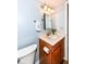 Well-lit bathroom with sink, wood cabinet, and updated fixtures at 12527 Trester Ln, Fishers, IN 46038