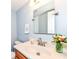 Bathroom with a wide sink, wood cabinet, and modern fixtures with the perfect amount of natural lighting at 12527 Trester Ln, Fishers, IN 46038