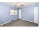 Cozy bedroom with carpet, a ceiling fan, and natural light from the window at 12527 Trester Ln, Fishers, IN 46038