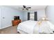 Bright bedroom with a large bed, gray curtains, a ceiling fan, and a dresser with a television at 12527 Trester Ln, Fishers, IN 46038