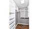 Organized walk-in closet with wooden floors, white shelving, and hanging rods for ample storage at 12527 Trester Ln, Fishers, IN 46038