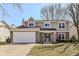 Attractive two-story home boasts a two-car garage, manicured lawn, and a patriotic American flag display at 12527 Trester Ln, Fishers, IN 46038