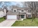Charming two-story home featuring a well-maintained lawn, attached two-car garage, and welcoming front entrance at 12527 Trester Ln, Fishers, IN 46038