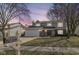 Inviting two-story house with attached garage, seen at dusk with a mailbox showing the street number at 12527 Trester Ln, Fishers, IN 46038