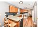 Traditional kitchen featuring wooden cabinets, granite countertops, and bar seating, open to other living areas at 12527 Trester Ln, Fishers, IN 46038