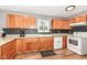 Functional kitchen with oak cabinets, granite countertops, white appliances, and stylish backsplash at 12527 Trester Ln, Fishers, IN 46038