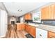 Charming kitchen featuring wood cabinets, granite counters, and stainless dishwasher near a cozy fireplace at 12527 Trester Ln, Fishers, IN 46038